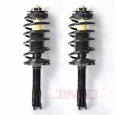 What is the role of the spring in a Saturn Strut Assembly?